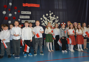 Uczniowie klasy 2a w patriotycznych barwach śpiewają pieśń