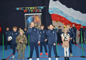 Grupa dzieci w różnym wieku, na tle dekoracji